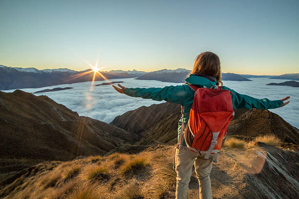 istock Hiker celebrates achievement, over the clouds 615410110