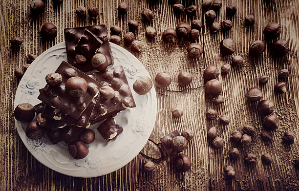 istock Chocolate and nuts: hazelnuts and pieces of dark chocolate 615410362