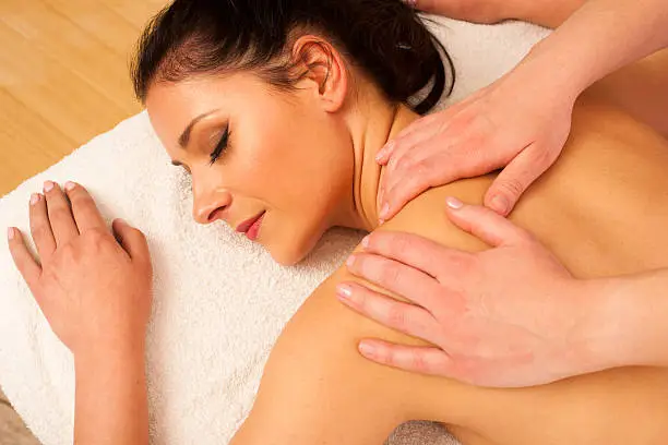 Beautifulyoung woman having a rejuvenating massage in a wellness studio - spa