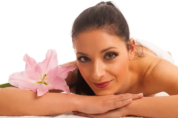 Beautifulyoung woman having a rejuvenating massage in a wellness studio - spa