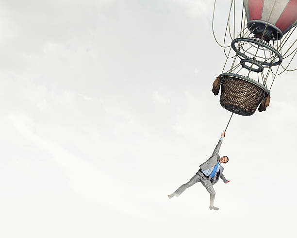 istock Man traveling in aerostat . Mixed media 615410944