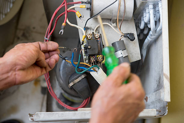 istock Air Conditioning Technician install new air conditioner. 615411546