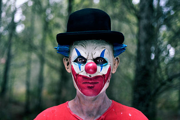 istock scary evil clown in the woods 615413770