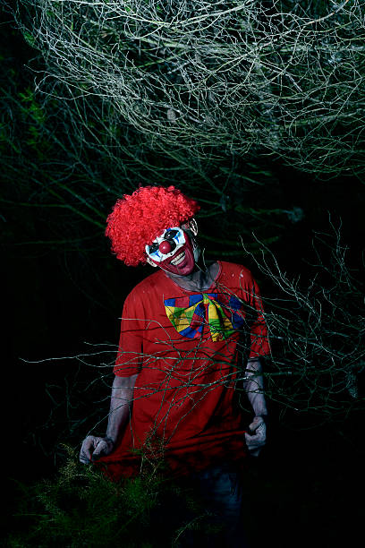 istock scary evil clown in the woods 615413846