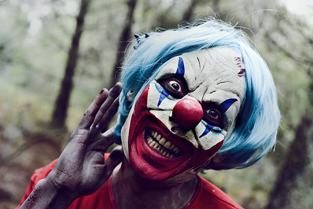istock scary evil clown in the woods 615413916