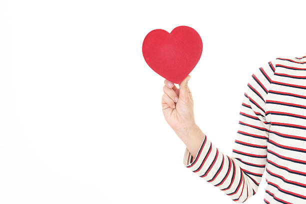 istock Woman holding a red heart 615416424