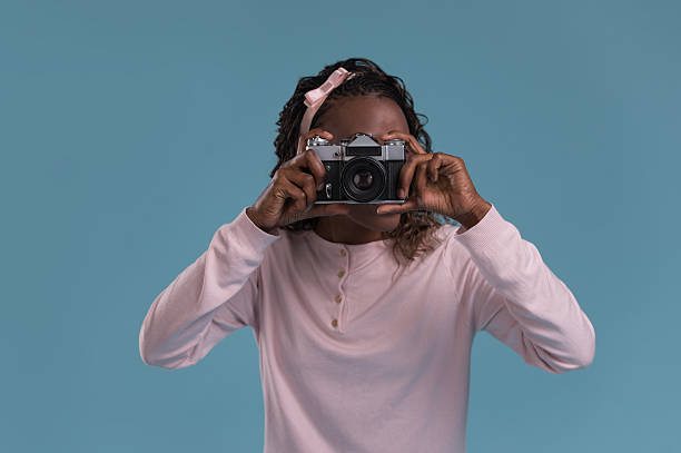istock Young african woman photographing 615416504