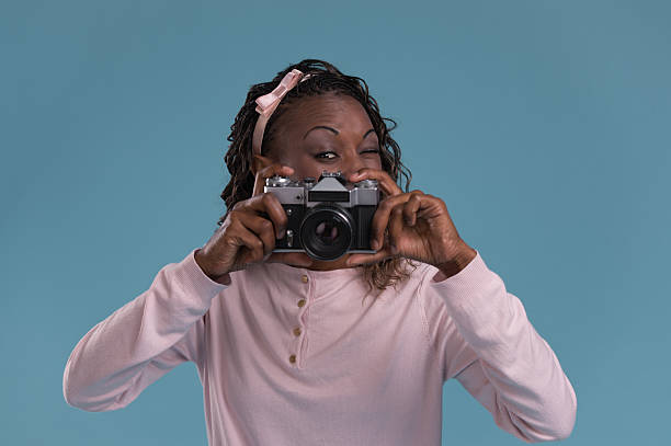 istock Young african woman photographing 615416642