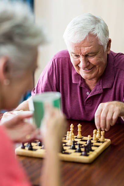 istock Senior couple playing chess 615418688