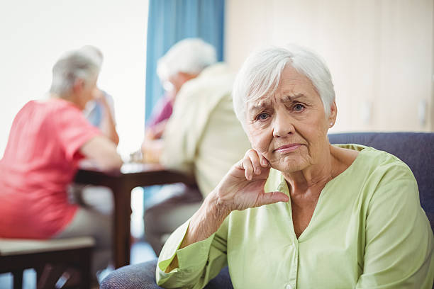 istock Senior woman sitting on a couch 615418816