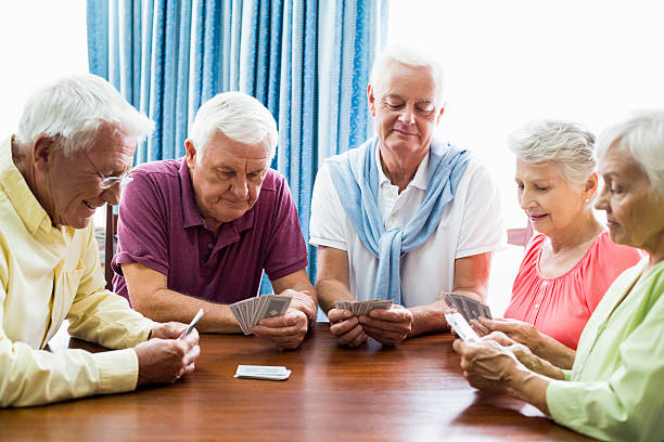 istock Seniors playing cards together 615419068