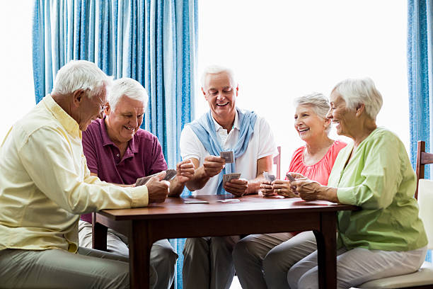 istock Seniors playing cards together 615419100