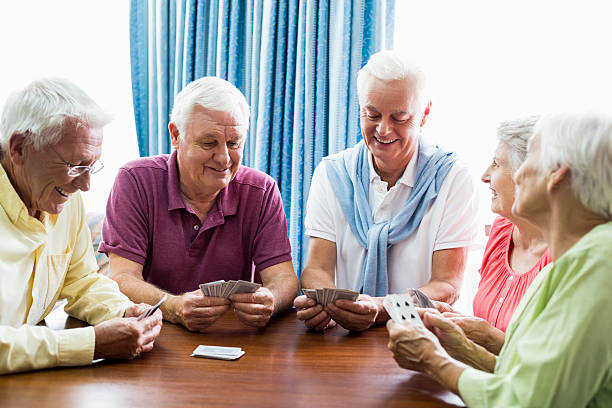istock Seniors playing cards together 615419108