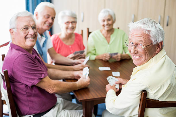 istock Seniors playing cards together 615419124