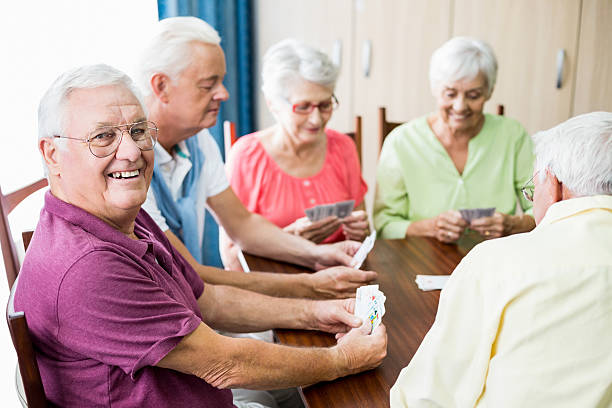 istock Seniors playing cards together 615419208