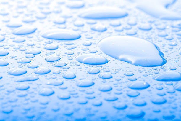istock Drops of water on a color background. Blue 615419582