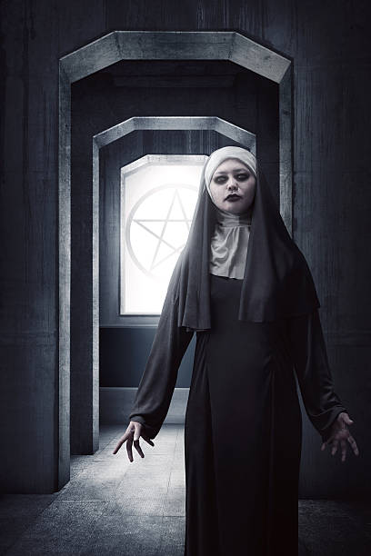 istock Asian woman dressed in evil nun standing 615420216