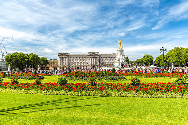London, United Kingdon - August 2, 2015: View of Buckingham Palace, one of the official residences of the British Royal Family and Victoria Memorial with crowds of people.