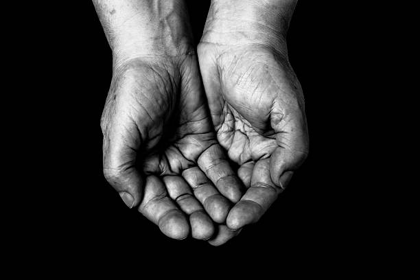 istock Hands of elderly woman on black background. Toned 615420848