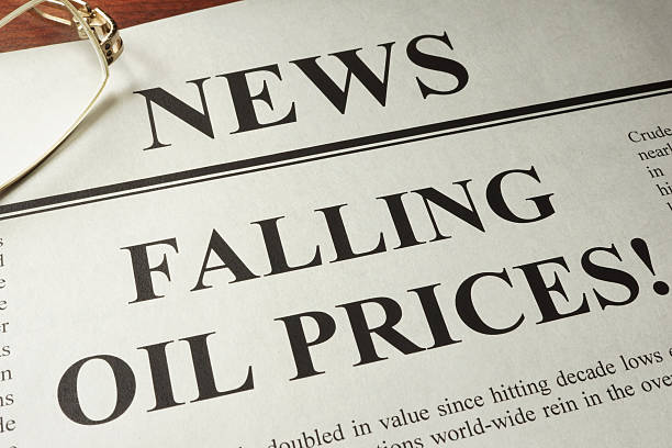 istock Newspaper with header news and Falling oil prices. 615421820