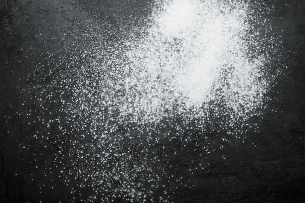 istock Flour spilling on black metal background. Toned 615422064