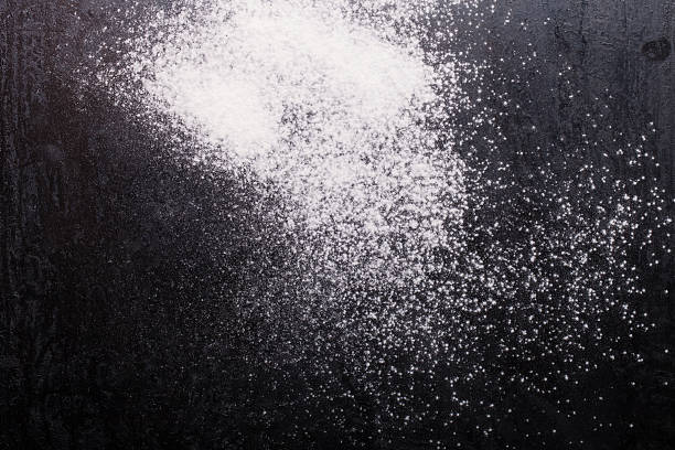 istock Flour spilling on black metal background 615422184