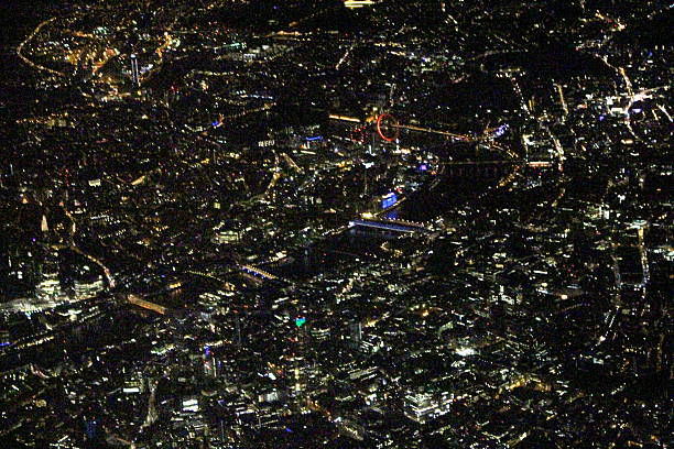 Aerial London Night London Eye Aerial of London at night featuring the Thames, London Eye and The Shard. View from North East London, looking towards the South.  waterloo bridge stock pictures, royalty-free photos & images
