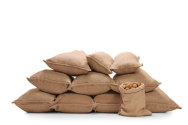 istock Pile of burlap sacks filled with potatoes 615424196