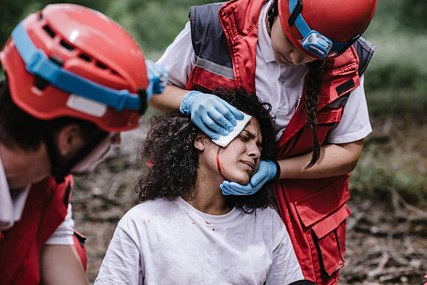 Rescue team treating injuries in the field Rescue team treating injuries in the field victim advocacy stock pictures, royalty-free photos & images