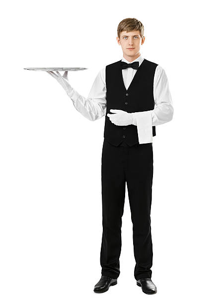 istock Full length portrait of handsome elegant waiter holding empty si 615424722