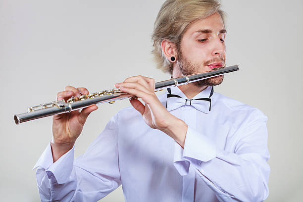 istock Male flutist playing his flute 615425040