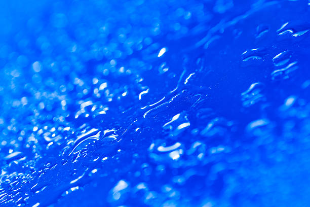 istock Drops of water on a color background 615425400