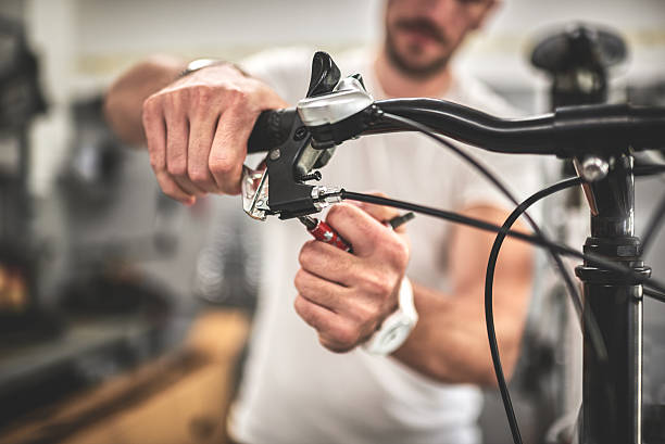istock Mechanic in bicycle store 615425402
