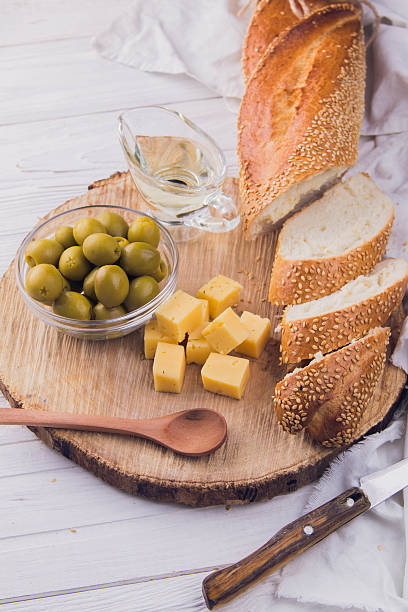 istock Ingredients for sandwich with cheese, baguette and olives 615425536