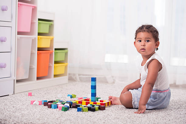 istock Little girl playing with block cubes. 615426434