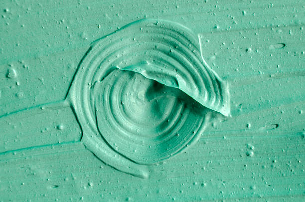 istock Green cosmetic clay texture close up. 615426530