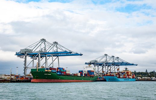 Auckland, New Zealand - November 11, 2014: Container ships with loading cranes in the Port of Auckland