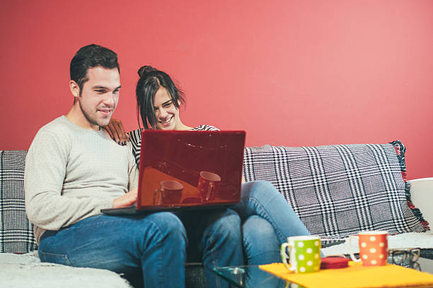 istock Young couple resting and surfing on internet with laptop 615427964