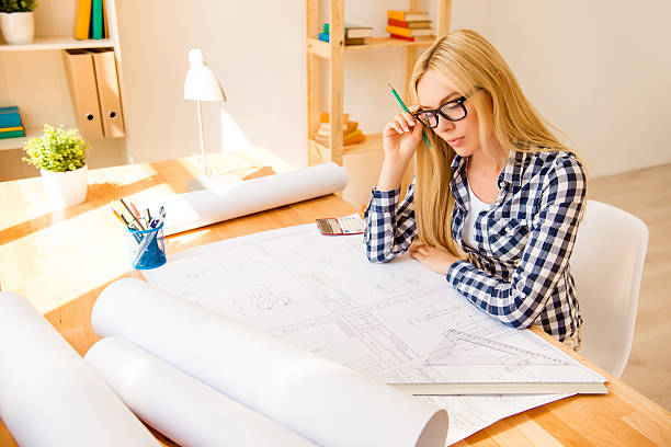 istock Pretty smart woman  drawing scheme for her project 615428320