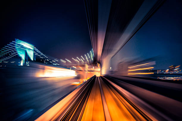 abstract motion-blurred view from a moving train abstract motion-blurred view from the front of a train in Tokio, Japan railroad track photos stock pictures, royalty-free photos & images