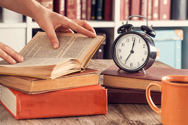 istock Books with reading glasses on desk 615429010