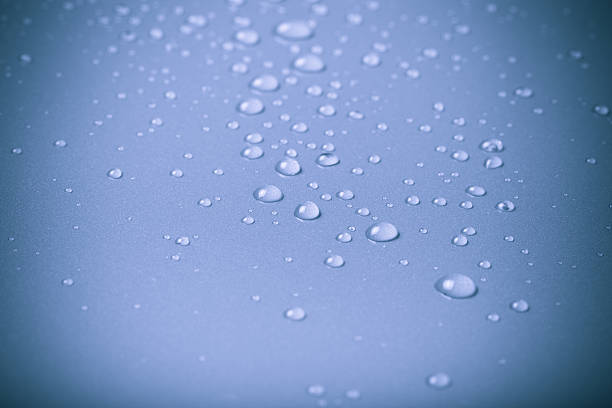 istock Drops of water on a color background. Blue 615429164