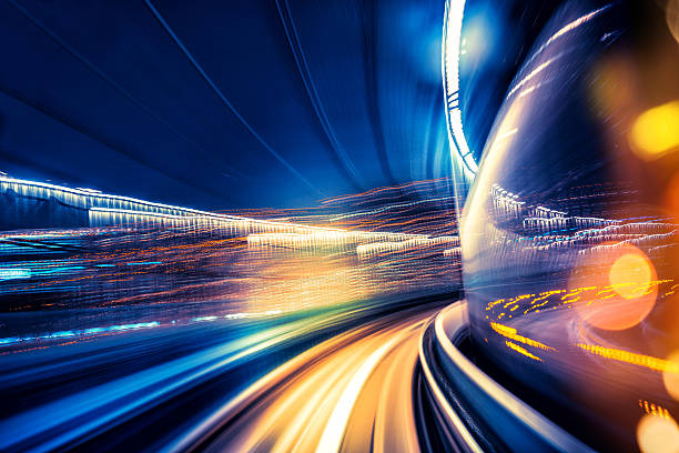 Abstract motion blurred city lights abstract motion-blurred view from the front of a train in Tokio, Japan light commercial vehicle stock pictures, royalty-free photos & images