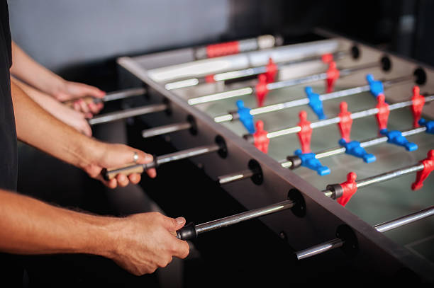 istock Friends having fun playing table foosball 615430274