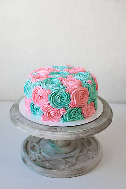 istock wedding cake decorated with cream roses close up 615431330