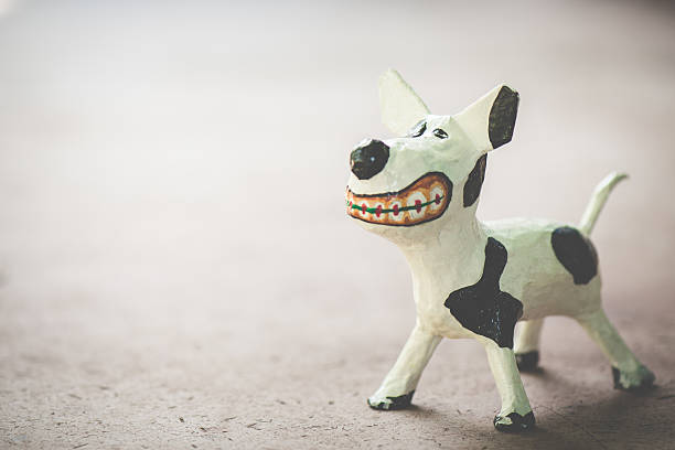 Models of a white dog, made from paper mache