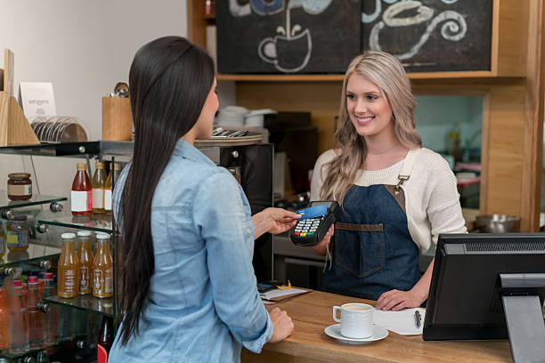istock Woman paying by card at the cafe 615432184