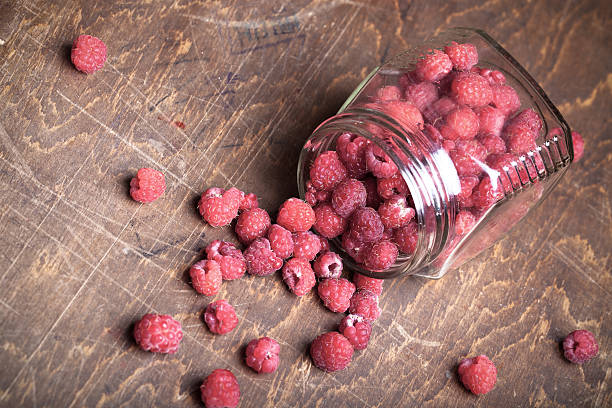 istock Lots of fresh bright red raspberries. Selective focus. Shallow d 615432322