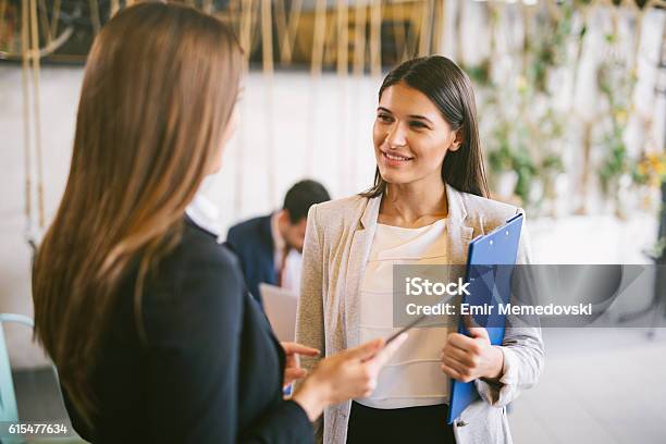 Two Young Businesswomen Discussing Business Strategy Using Digital Tablet Stock Photo - Download Image Now