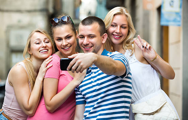 istock young people taking selfie outdoors 615478484